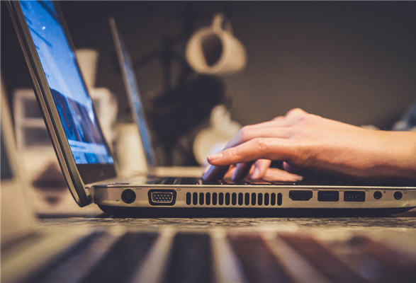 fingers typing on a keyboard